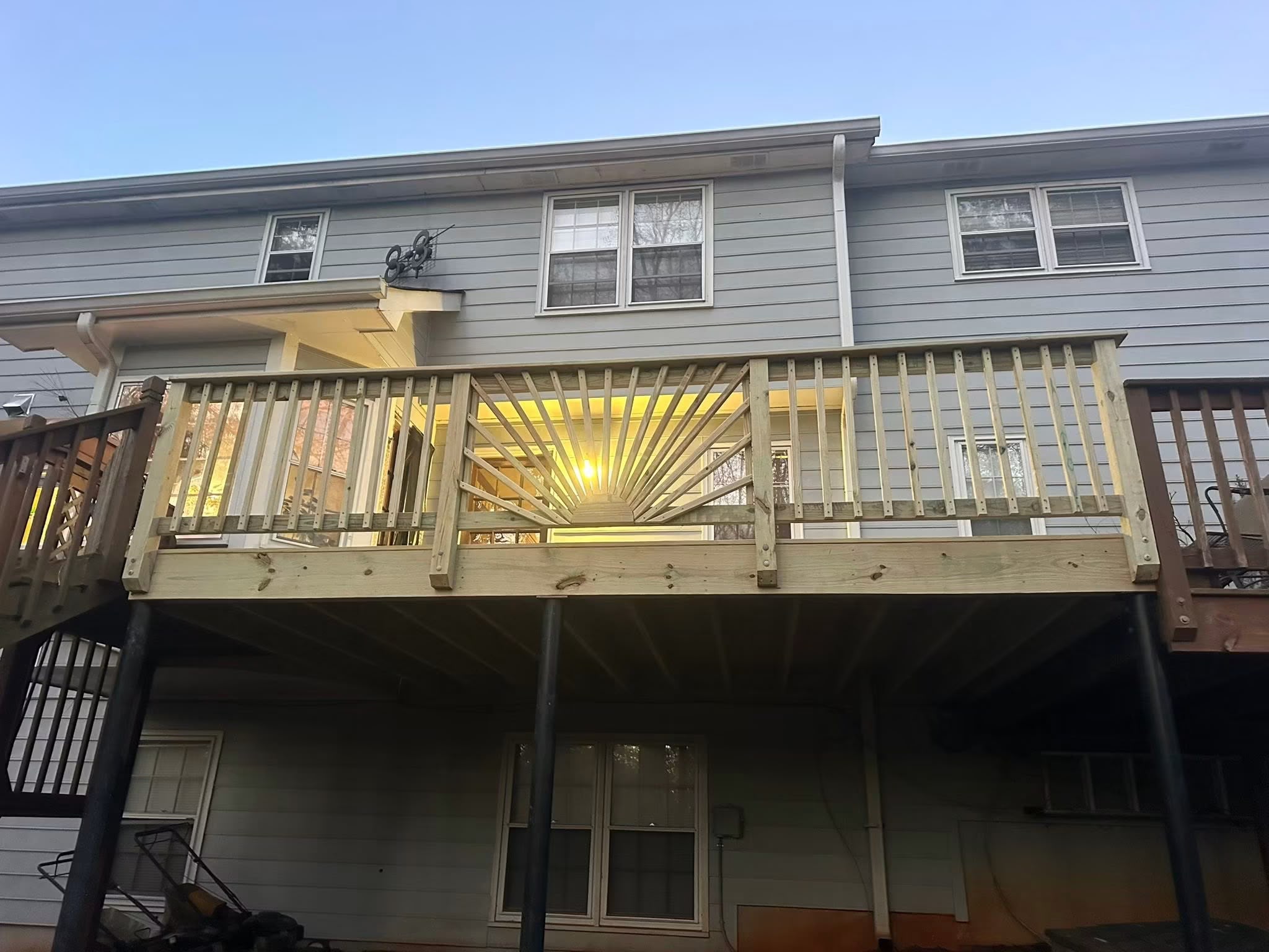 After: handcrafted elevated wooden deck with custom sunburst railing design